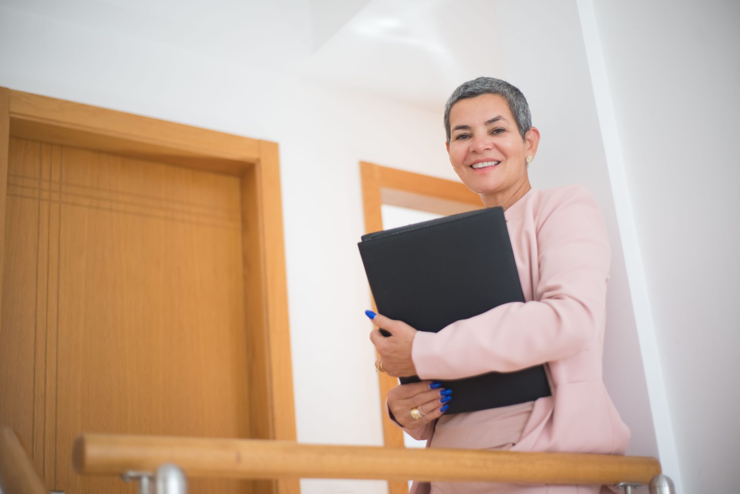 Femme d'affaires souriante blazer rose documents